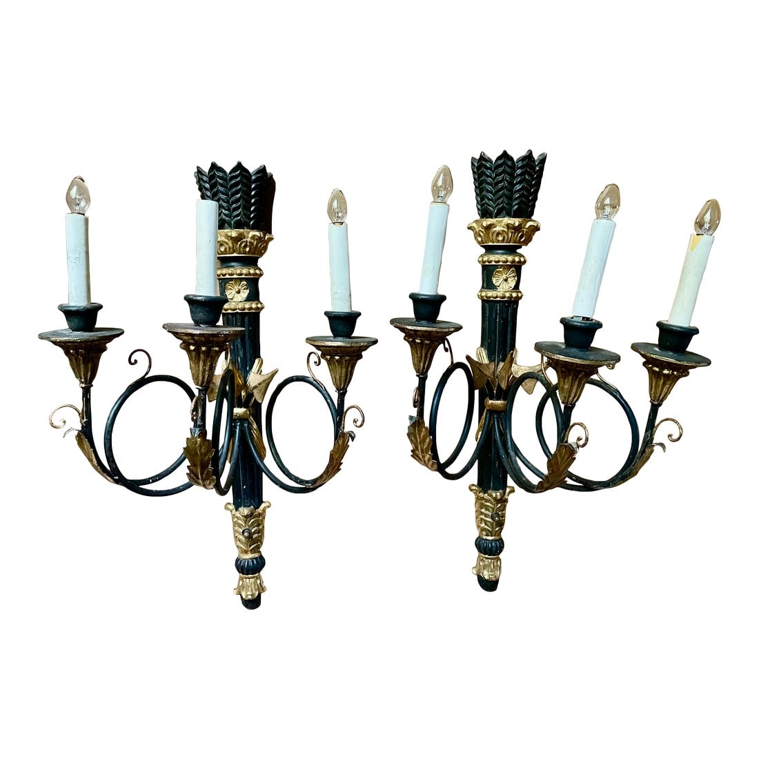 Pair Neoclassic Italian Carved Wood Iron Black Gold Painted Arrow Wall Sconces: This is a sweet pair of neoclassical style wall sconces with a stylized arrow motif which starts with the feather on the carved wood crown of the column back and continues to the coiled wrought iron a