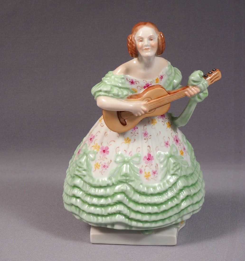 Herend Hungary Mrs Derry Playing Guitar Figurine 5796 LARGE 8 7/8" Deryne: Title: Herend Hungary Mrs Derry Playing Guitar Figurine 5796 LARGE 8 7/8" DeryneDescription: . This is an exceptional Figurine made by Herend in Hungary. The figurine is marked with Herend older