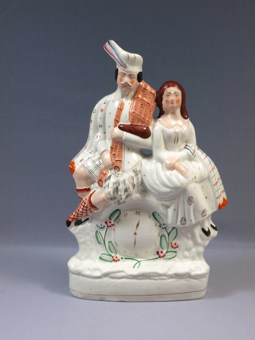 STAFFORDSHIRE Figure Scottish man lady Gat Clock couple Antique Victorian: Title: STAFFORDSHIRE Figure Scottish man lady Gat Clock couple Antique Victorian Description: . This is a beautiful Staffordshire figurine depicts a Scottish couple dressed in period outfit seated ove