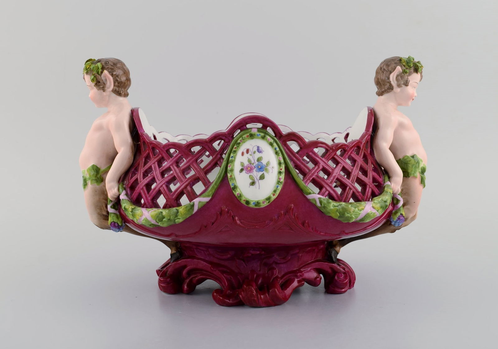 Large antique Meissen centrepiece in openwork hand-painted porcelain decorated with fauns. Approx.: Title: Large antique Meissen centrepiece in openwork hand-painted porcelain decorated with fauns. Approx. 1910 Description: Large antique Meissen centrepiece in openwork hand-painted porcelain decorat