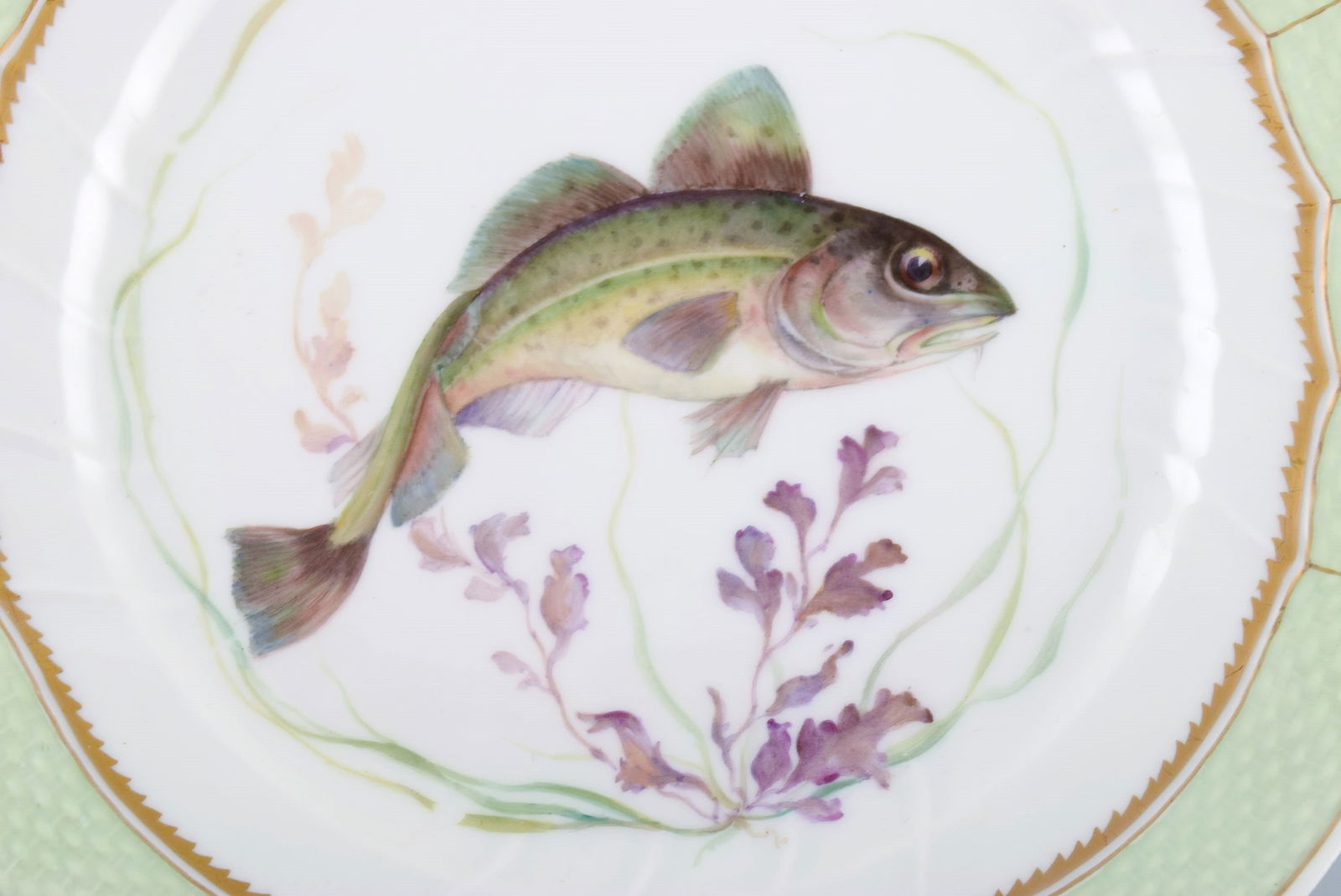 Royal Copenhagen fish plate with green edge, gold decoration and fish motif. Model 919/1710. - 2