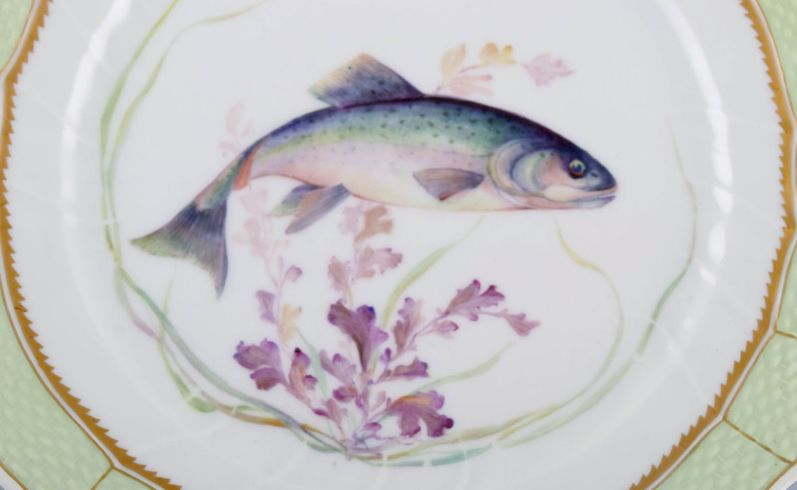 Royal Copenhagen fish plate with green edge, gold decoration and fish motif. Model 919/1710. - 2