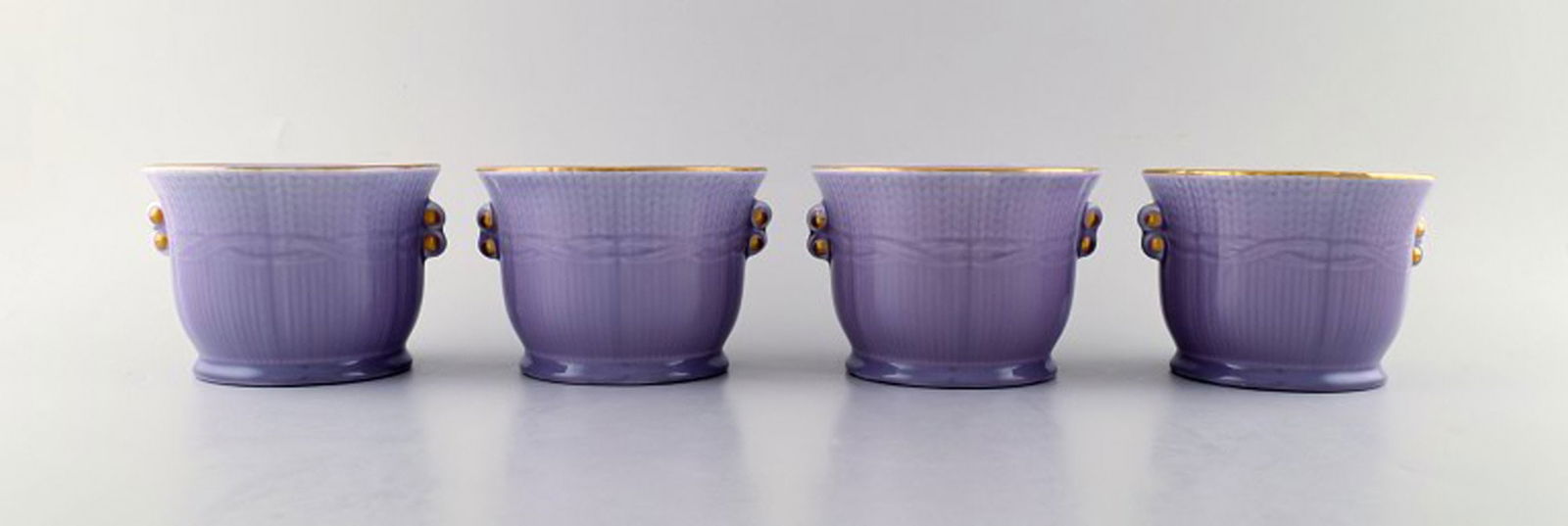 Louise Adelborg (b.1885, 1971) for Rörstrand / Rørstrand, Sweden. Set of four Swedish: Title: Louise Adelborg (b.1885, 1971) for Rörstrand / Rørstrand, Sweden. Set of four Swedish Grace flower pots in purple with gold decoration. 1930 / 40s'. Description: Louise Adelborg