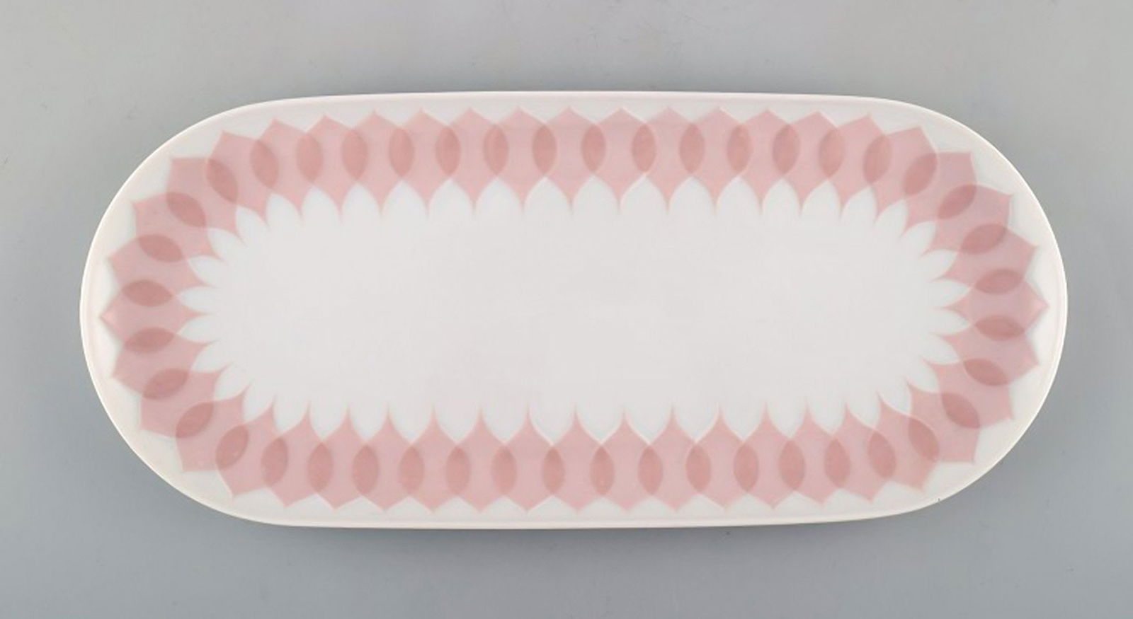 Bjørn Wiinblad for Rosenthal. "Lotus" porcelain service. Oblong dish decorated with pink lotus: Title: Bjørn Wiinblad for Rosenthal. "Lotus" porcelain service. Oblong dish decorated with pink lotus leaves. 1980's. Description: Bjørn Wiinblad for Rosenthal. "Lotus" porcelain service.