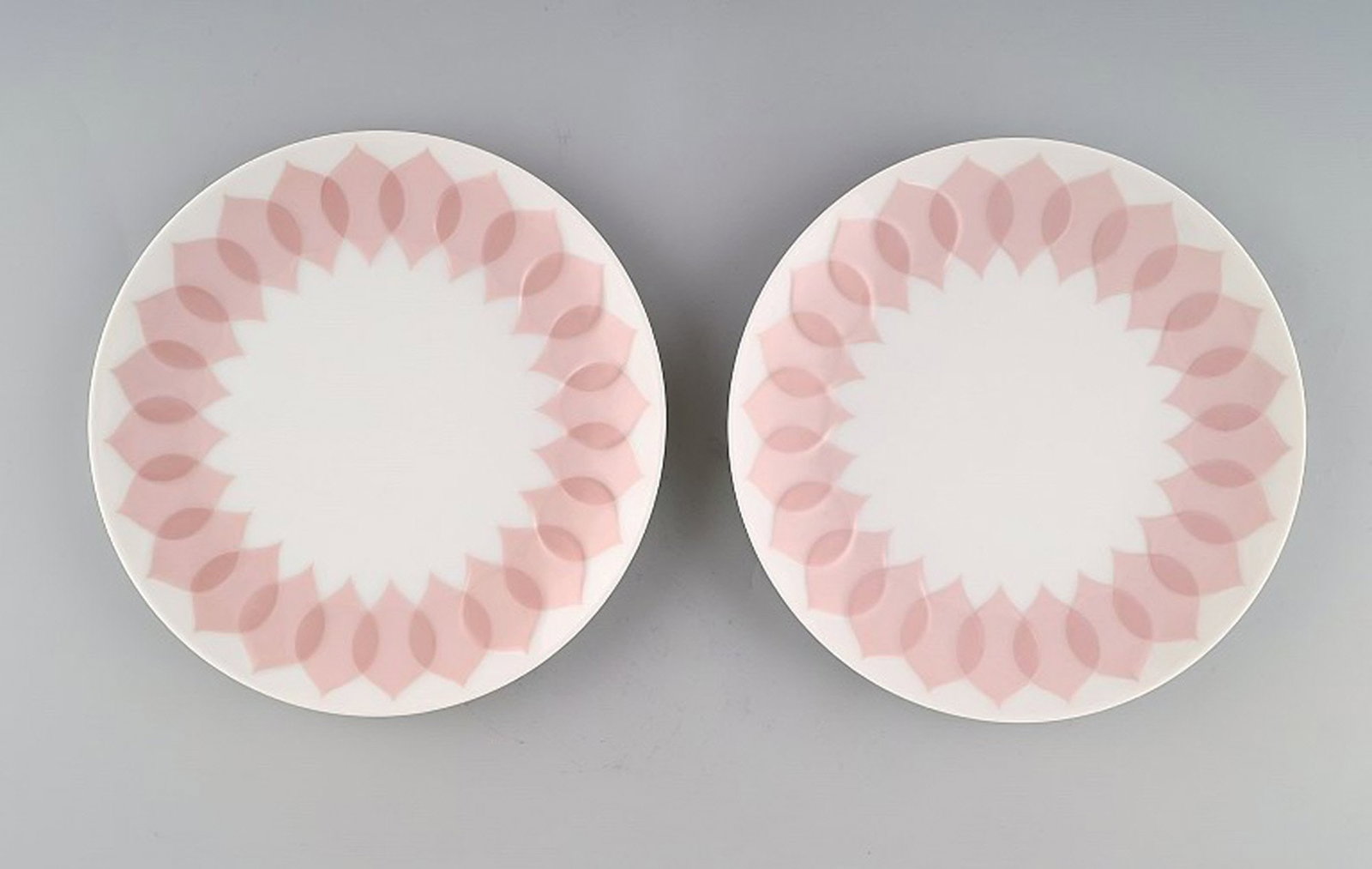 Bjørn Wiinblad for Rosenthal. "Lotus" porcelain service. Two plates decorated with pink lotus: Title: Bjørn Wiinblad for Rosenthal. "Lotus" porcelain service. Two plates decorated with pink lotus leaves. 1980s. Description: Bjørn Wiinblad for Rosenthal. "Lotus" porcelain service. Two