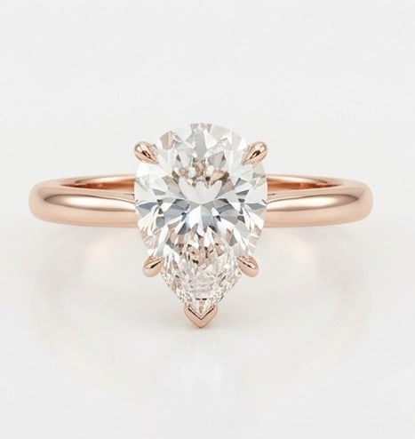 4 Ct Lab Grown Diamond Pear Shape Solitaire Ring in 14K Rose Gold: Title: 4 Ct Lab Grown Diamond Pear Shape Solitaire Ring in 14K Rose Gold Description: Stunning 4 carat lab grown diamond ring featuring a Pear Shape Solitaire design. The center stone is beautifully s