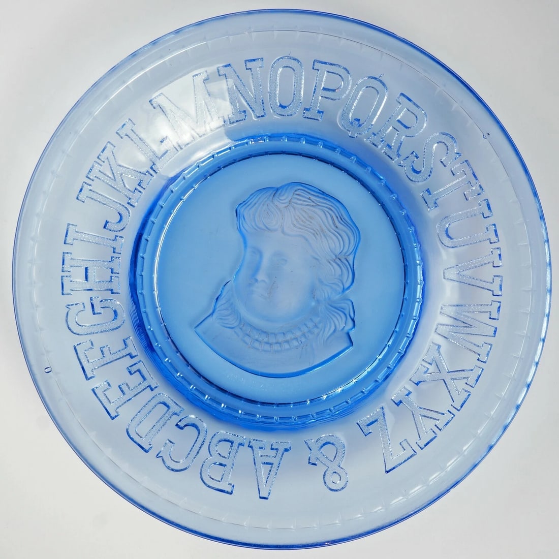 Vintage Cobalt Blue Child's Alphabet Plate: Title:Vintage Cobalt Blue Child's Alphabet PlateSize:8 in (20.3 cm) diameter x 1 1/4 in (3.2 cm) deep.Description:This 8 in child's plate has alphabet letters with a frosted glass impression of a