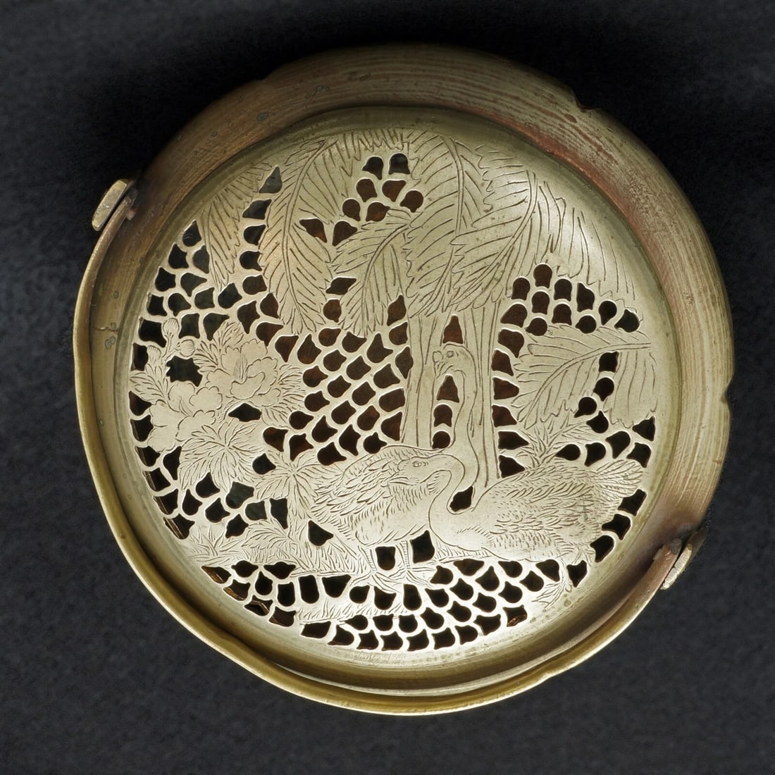 Chinese Copper Handled Hand Warmer c 1900: Title:Chinese Copper Handled Hand Warmer c 1900Size:3 1/2 in (8.9 cm) tall x 5 1/2 in (14.0 cm) diameter.Description:A round scalloped body has a lid that is pierced with a decoration of geese,