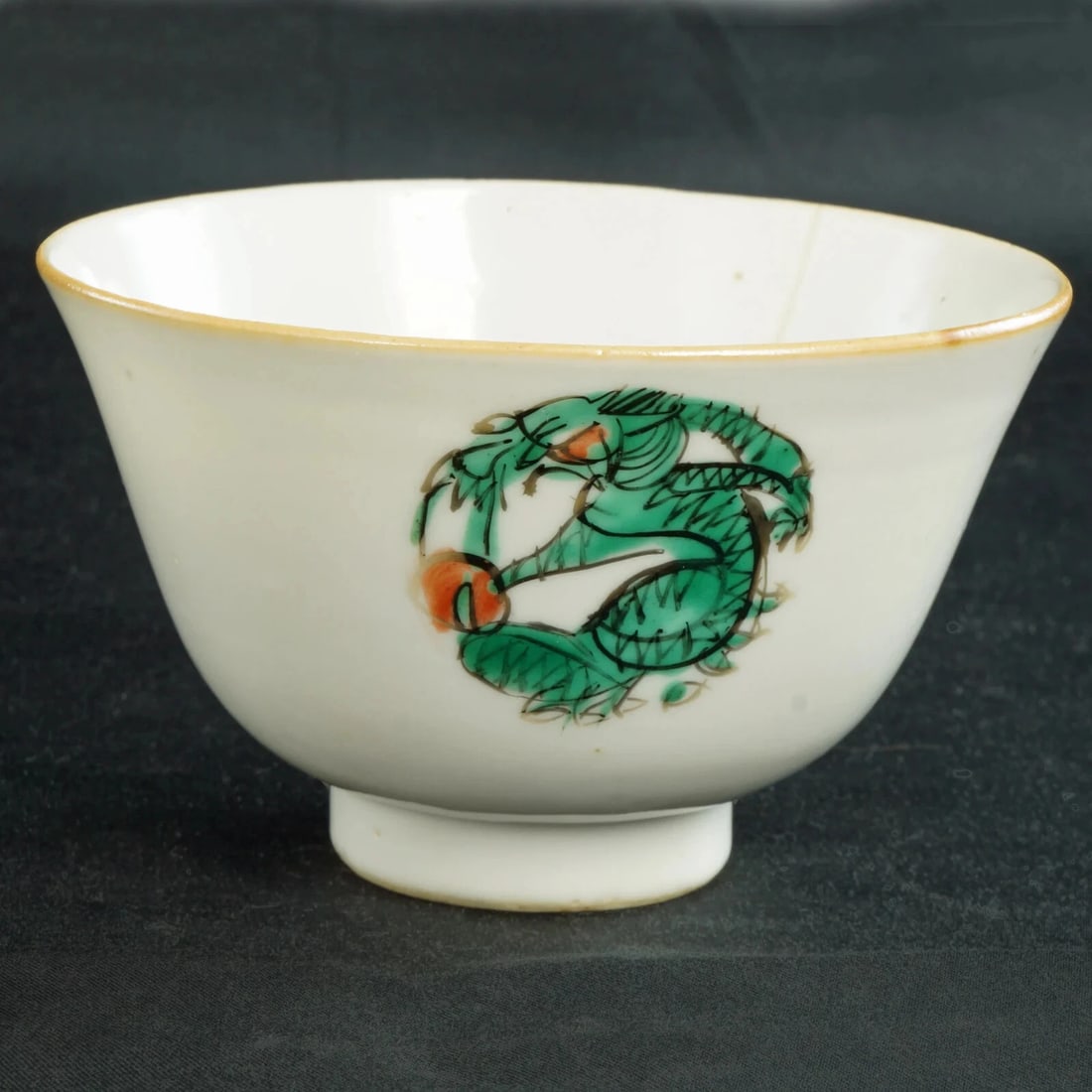 1920s Chinese Polychrome Porcelain Tea Bowl: Title:1920s Chinese Polychrome Porcelain Tea Bowl Size:3 7/8 in (9.8 cm) diameter x 3 3/8 in (8.4 cm) tall. Description:A well-potted and hand painted tea bowl or cup with dragons and the flaming pear