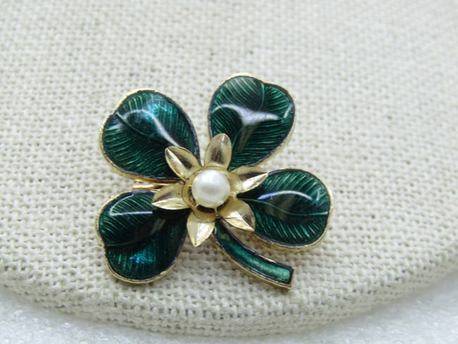 Vintage Green Enameled Four-Leaf Clover Brooch, Faux Pearl, 1": DescriptionVintage Green Enameled Four-Leaf Clover Brooch, Faux Pearl, 1", gold tone with petals surrounding the center faux pearl. 1960's-1970's. Not isgned by the maker. Very good condition. (INV. W