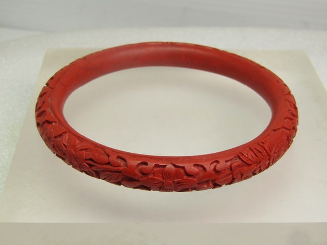 Vintage Cinnabar Rounded Bangle Bracelet, 8" , 1960's-1970's: DescriptionVintage Cinnabar Rounded Bangle Bracelet, 8" , 1960's-1970's. It is appx. 9mm thick with a carved outer edge and a smooth inner edge that is also rounded. Carved leaves and blossoms are aro