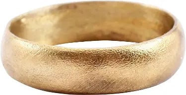 LARGE VIKING WEDDING RING, SIZE 11 1/4: 9th century, Cambridgeshire England. Bronze, with a rounded face and of broad 6.0mm width. Vikings exchanged rings on the pommel of the groom's sword. Surface textured from burial. Professionally refu