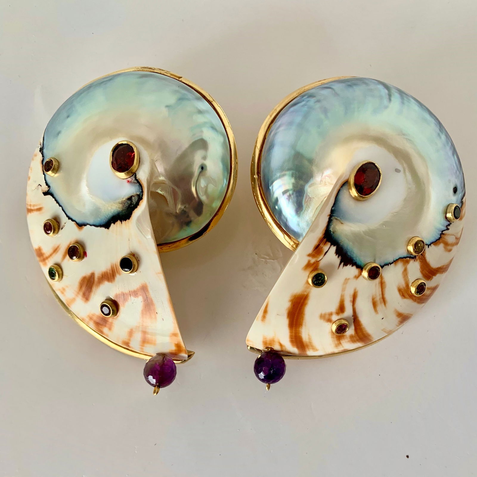 Bold Nautilus, Gemstone Vermeil Earrings: Title:Bold Nautilus, Gemstone Vermeil EarringsDescription:Not for wimps, these wonderful, big, bold Nautilus earrings are set with colored Tourmalines and large, faceted Garnets in the center. They