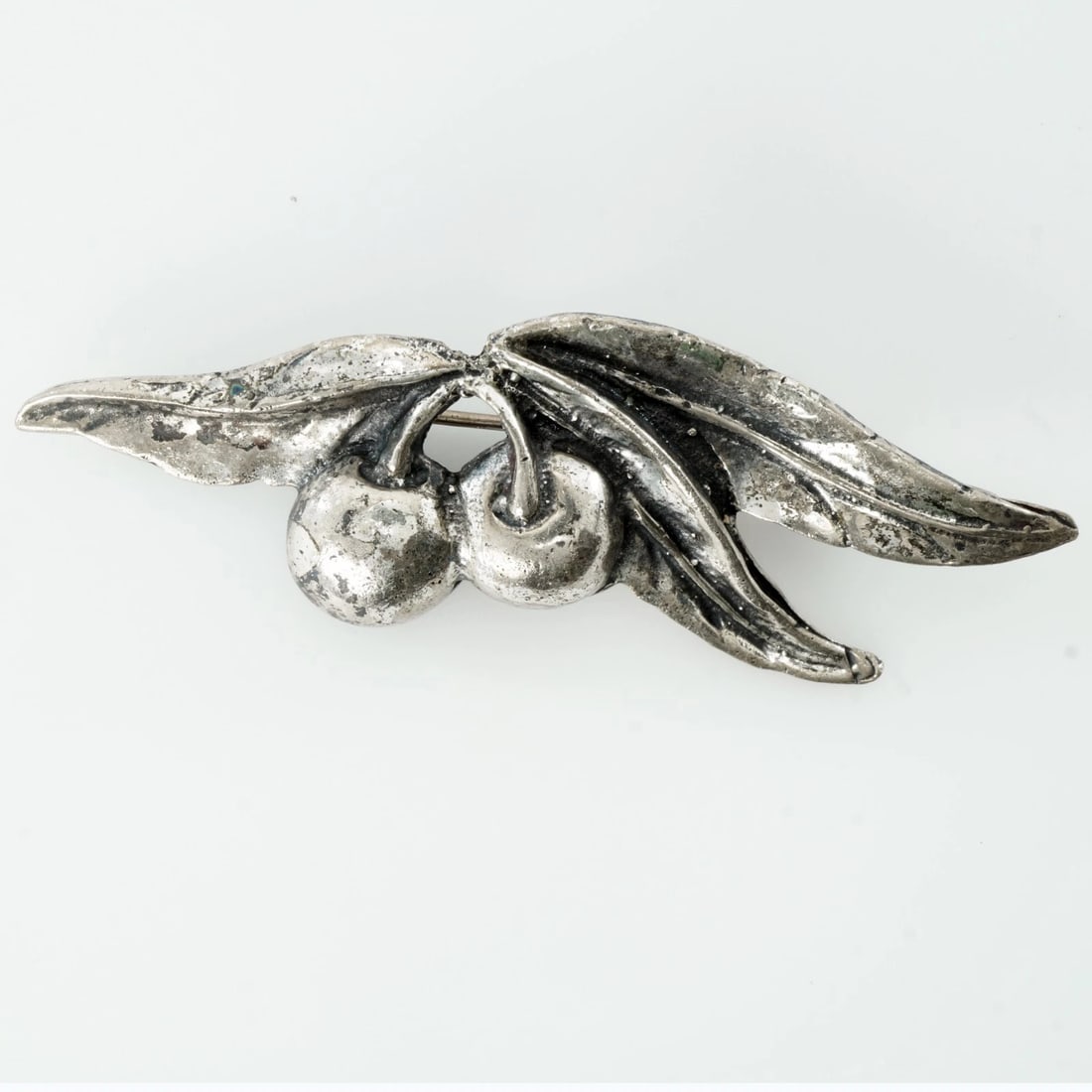 Vintage Brockraft Signed Sterling Brooch Pin: Title:Vintage Brockraft Signed Sterling Brooch PinSize:2 ¾ in (7.0 cm) wideDescription:The brooch pin depicts two berries nestled among textured leaves. It has a simple “C in clasp and is