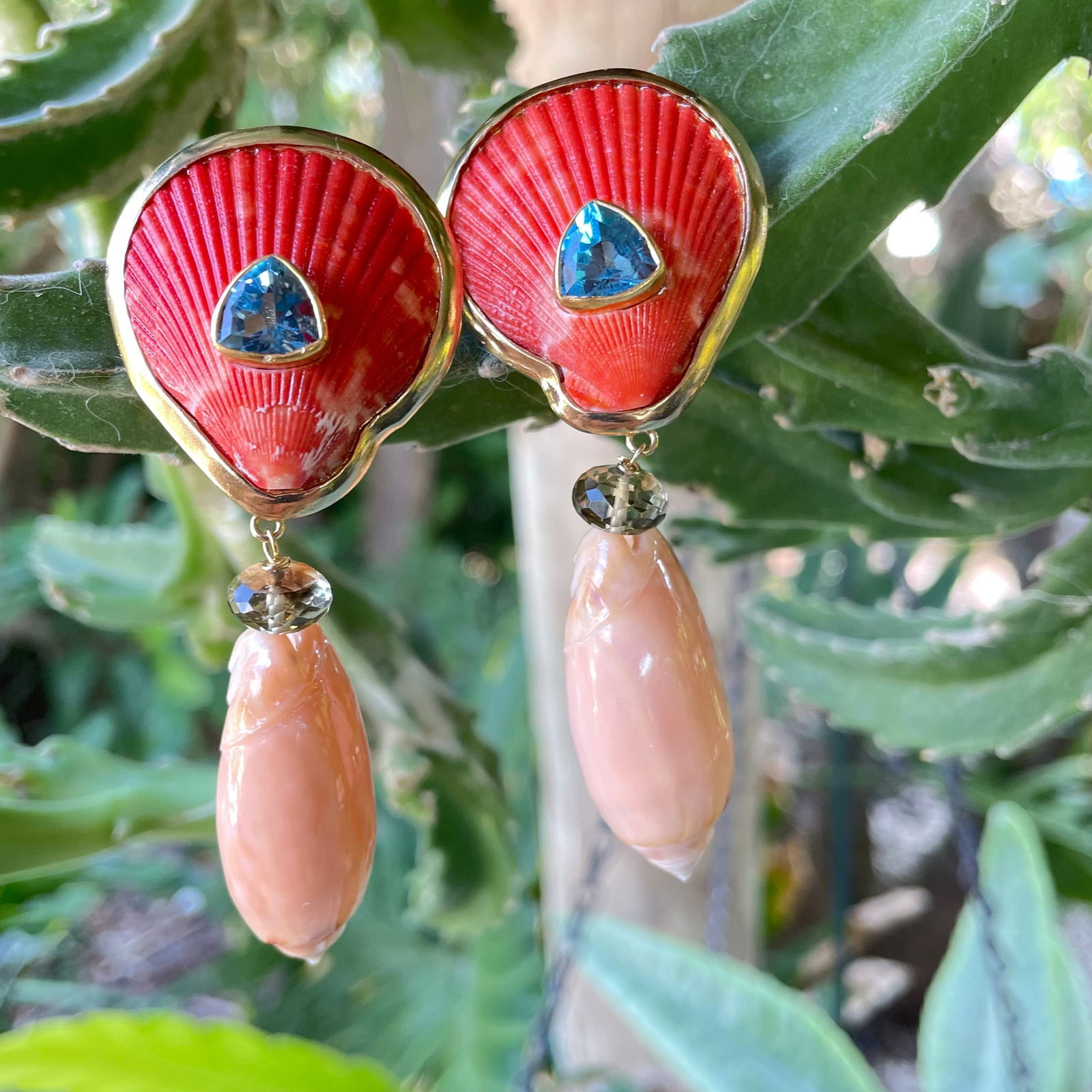 Scallop and Pink Olive Shell Earrings with Topaz and Citrine: Title:Scallop and Pink Olive Shell Earrings with Topaz and CitrineDescription:Pair of burnt orange Scallops set with gorgeous faceted Sky Blue Topaz Trillions. Drops of Pink Olive shells topped off