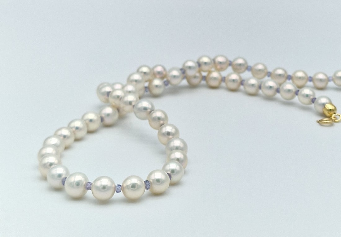 Akoya pearl necklace with tanzanite and 18kt yellow gold: Title:Akoya pearl necklace with tanzanite and 18kt yellow gold Description:3 strands of fresh water pearl bracelet with central cameo and 925 silver clasp Pearls diameter 6.5 mm Excellent shine Centra