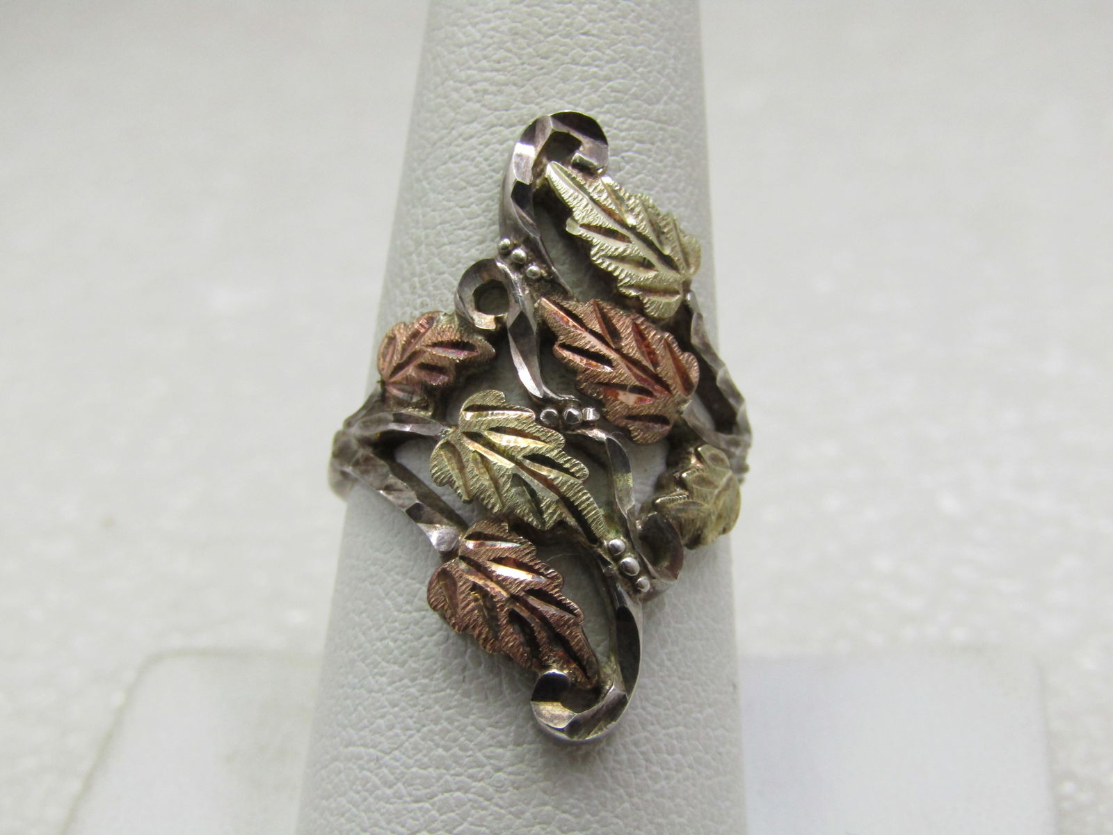 Vintage 10kt & Sterling Black Hills Gold Ring, Sz. 8,: Title:Vintage 10kt & Sterling Black Hills Gold Ring, Sz. 8,Description:Vintage 10kt & Sterling Black Hills Gold Ring, Sz. 8, appx. 4.84 gr. Nearly 1.25" long down the finger and crosses over the