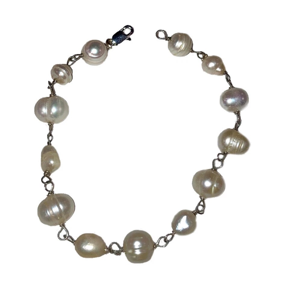 Sterling Silver Hand Made Artisan Cultured Pearl Bracelet: Title:Sterling Silver Hand Made Artisan Cultured Pearl BraceletDescription:Sterling silver hand made Artisan cultured pearl bead bracelet. Bracelet measures 7 1/4" long by 1/4" wide. Sterling