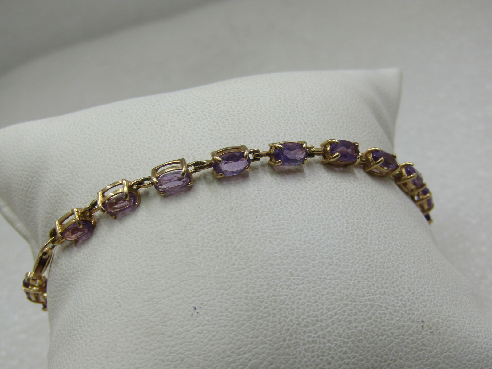 Vintage 10kt Amethyst Tennis Bracelet, 7.25".: Title:Vintage 10kt Amethyst Tennis Bracelet, 7.25".Description:Vintage 10kt Amethyst Tennis Bracelet, 7.25". The bracelet is appx 3mm wide, lobster clasp. Signed 10kt and tested. Weight is appx. 4.38