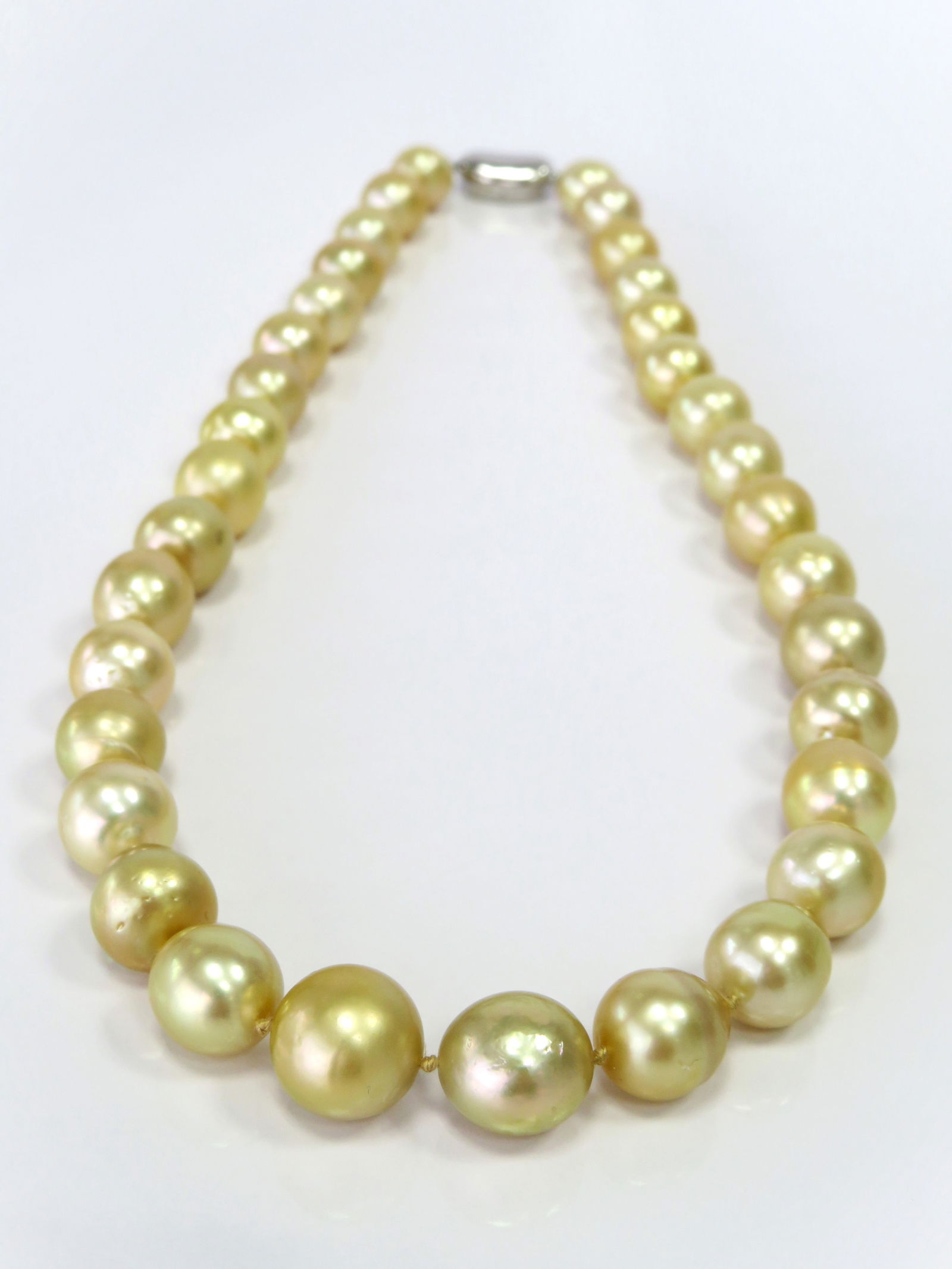 10-14mm Drop/Oval Golden South Sea Pearl Necklace: Title:10-14mm Drop/Oval Golden South Sea Pearl Necklace Description:A-AA Grade High luster, Golden Oval/Drop, with minimal spots/blemishes, 34 pearl pieces, 18 inches long hand-knotted with 925