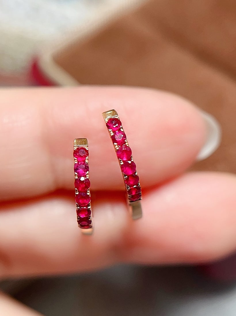 18K Gold Natural Ruby Earrings: Title: 18K Gold Natural Ruby Earrings Description: These earrings showcase the captivating charm of natural rubies, set in exquisite 18K gold. The rich pigeon blood red color of the rubies is a