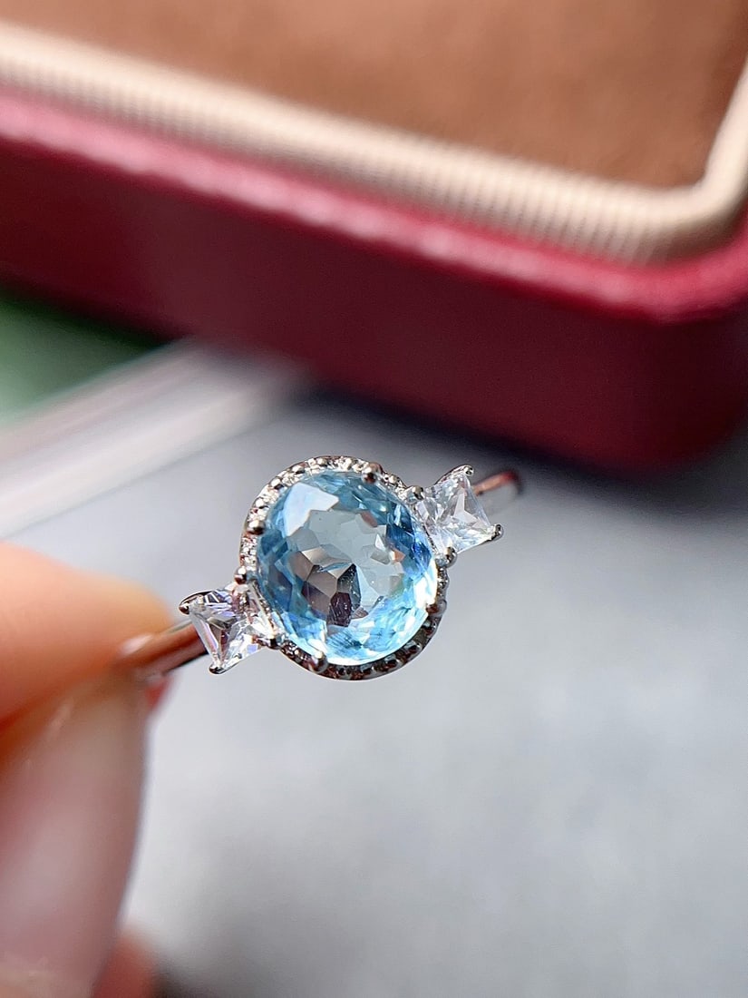 18k Gold Aquamarine Ring: Title: 18k Gold Aquamarine Ring Description: This exquisite ring features a natural aquamarine as the main stone, renowned for its calming ocean blue hue. The meticulously crafted 18K gold setting enh