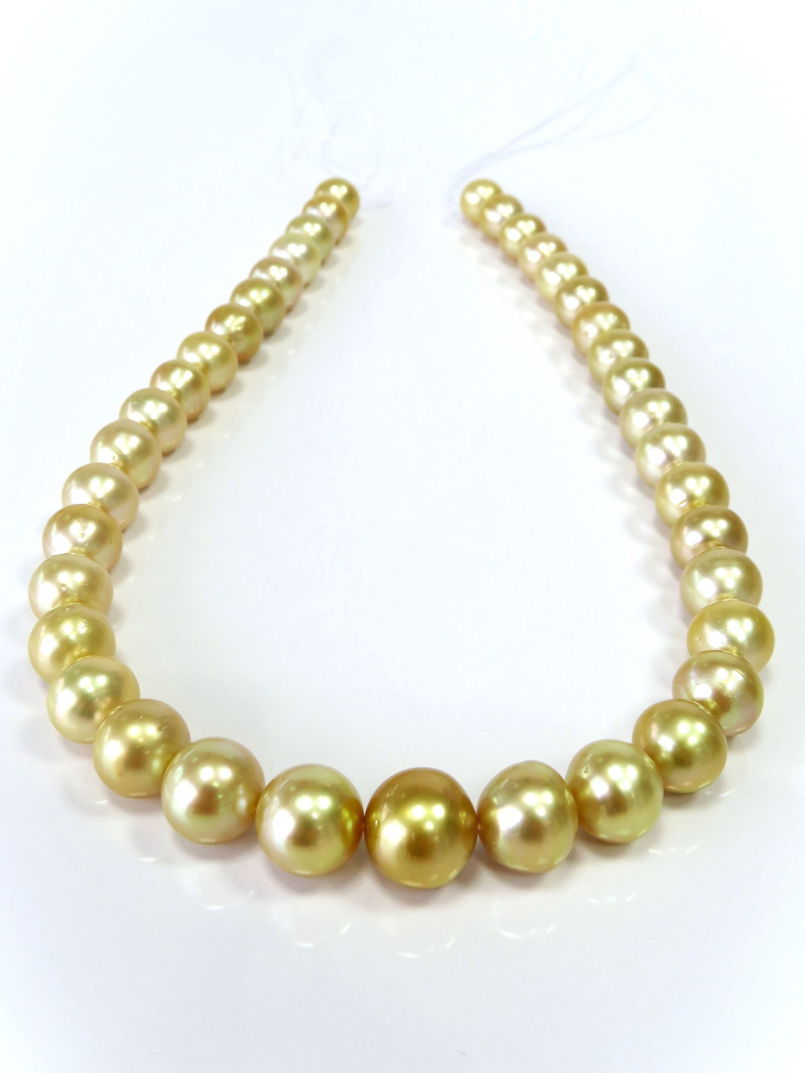 10-13mm Round/Button Golden South Sea Pearl Necklace Strand: Title:10-13mm Round/Button Golden South Sea Pearl Necklace Strand Description:AA-Grade High luster Golden Round/Button, with minimal spots/blemishes, 39 pearl pieces, 18 inches long hand-knotted with