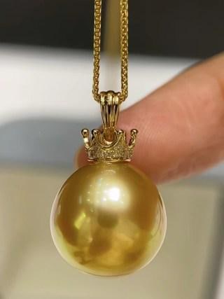 South Sea gold pearl natural color pendant: Title: South Sea gold pearl natural color pendant Description: South Sea Golden Pearl natural color pendant 13-14mm near-round with minor flaws, extremely strong luster, beautifully dark tea-gold
