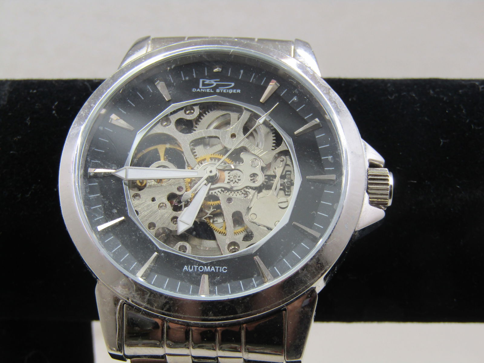 Daniel Steiger Skeleton Automatic Men's Watch, Stainless Steel, Wide Woven Band: Title: Daniel Steiger Skeleton Automatic Men's Watch, Stainless Steel, Wide Woven Band Description: Daniel Steiger Skeleton Automatic Men's Watch, Wide Woven Band - Unisex Too. It has a 1 MD on