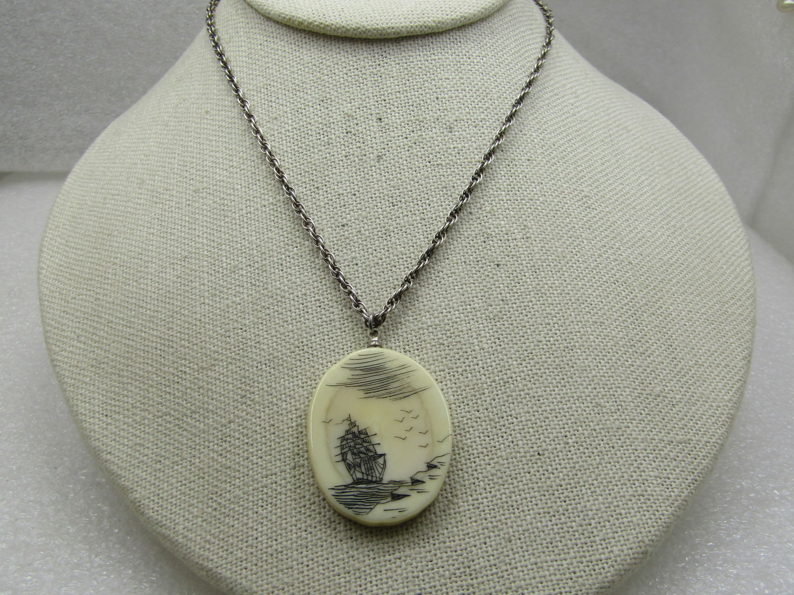 Vintage Sterling Scrimshaw Ship At Sea Necklace, 20": Title: Vintage Sterling Scrimshaw Ship At Sea Necklace, 20" Description: Vintage Scrimshaw Ship At Sea Necklace, 20". Carved tall sail ship at see with birds and cliffs. The pendant is appx. 1.5"