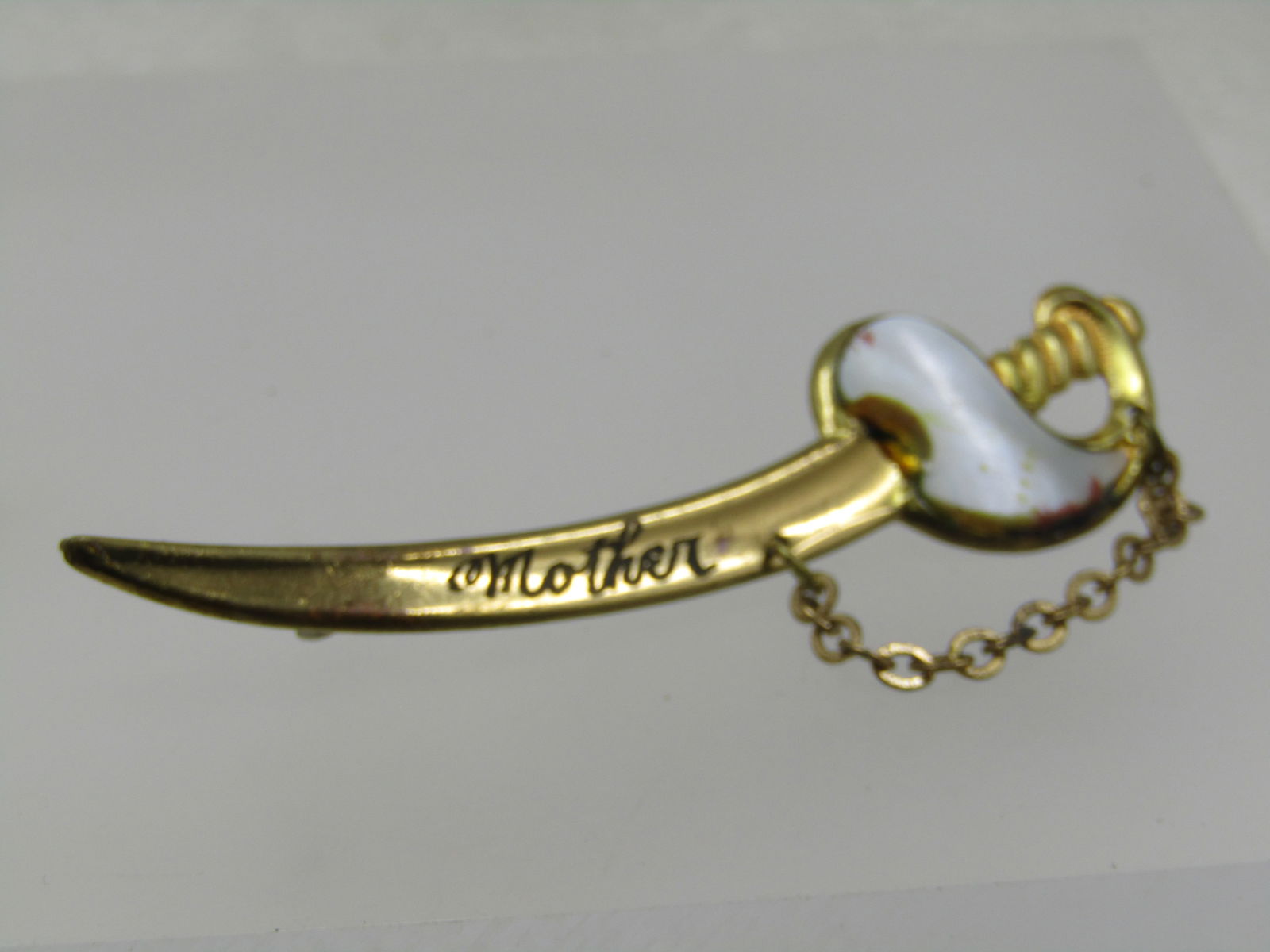 Vintage Sword Brooch, Engraved Mother, MOP Hilt, 1930's-1940's: Title: Vintage Sword Brooch, Engraved Mother, MOP Hilt, 1930's-1940's Description: Vintage Sword Brooch, Engraved Mother, MOP Hilt, 1930's-1940's, C-Clasp. This is 3" long, and appx. 3/4" high. 