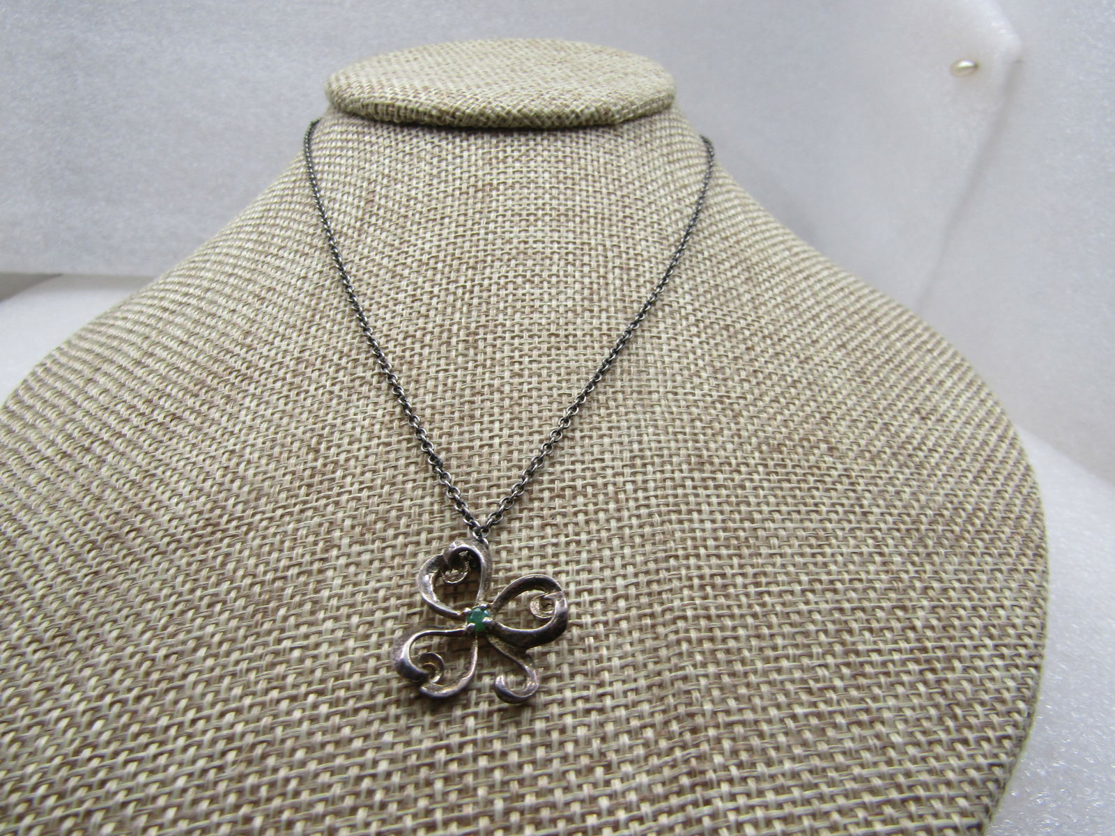 Vintage Sterling Three Leaf Clover Emerald Necklace, 15.75" Chain: Title: Vintage Sterling Three Leaf Clover Emerald Necklace, 15.75" Chain Description: Vintage Sterling Three Leaf Clover Emerald Necklace, 15.75" Chain. The pendant has an apx. 1.5mm round emerald