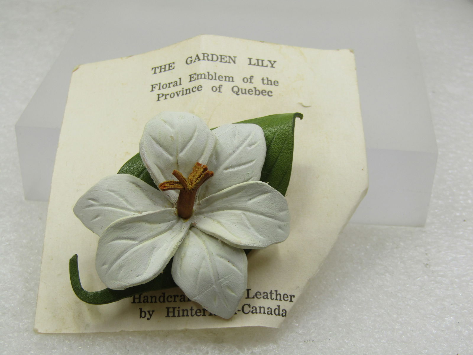 Vintage Leather Garden Lily Brooch, Hinterland-Canada, On Card: Title: Vintage Leather Garden Lily Brooch, Hinterland-Canada, On Card Description: Vintage Leather Garden Lily Brooch, Hinterland-Canada, On Card. The brooch is white and green leather with brown leat