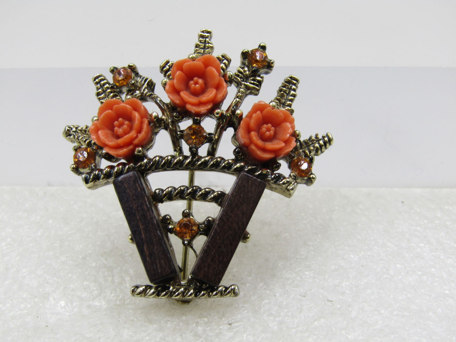 Vintage Pressed Celluloid Rose & Rhinestone Basket Brooch, 1960's: Title: Vintage Pressed Celluloid Rose & Rhinestone Basket Brooch, 1960's Description: Vintage Pressed Celluloid Rose & Rhinestone Basket Brooch, 1960's. This has wood accents with rope accent basket a