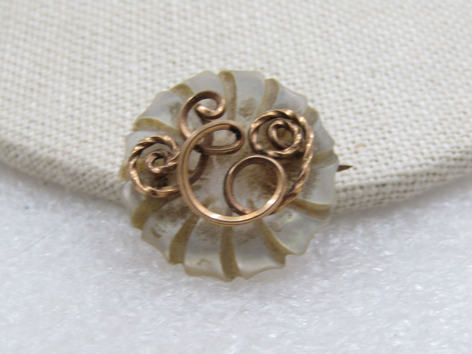 Vintage Carved Mother-of-Pearl Initial E Brooch: Title: Vintage Carved Mother-of-Pearl Initial E Brooch Description: Vintage Carved Mother-of-Pearl Initial E Brooch, 10kt GF. Scrolls and Initial E set over a spiral carved mother-of-pearl base that