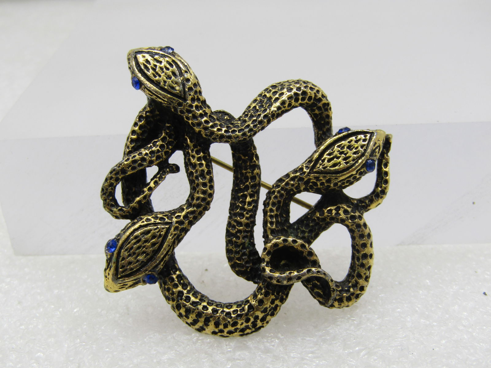 Vintage Triple Snake Brooch, Rhinestone Eyes, Gold Tone, Post Mid-Century: Title: Vintage Triple Snake Brooch, Rhinestone Eyes, Gold Tone, Post Mid-Century Description: Vintage Triple Snake Brooch, Rhinestone Eyes, Gold Tone, Post Mid-Century. It is appx. 1.5" by 1.75" . 
