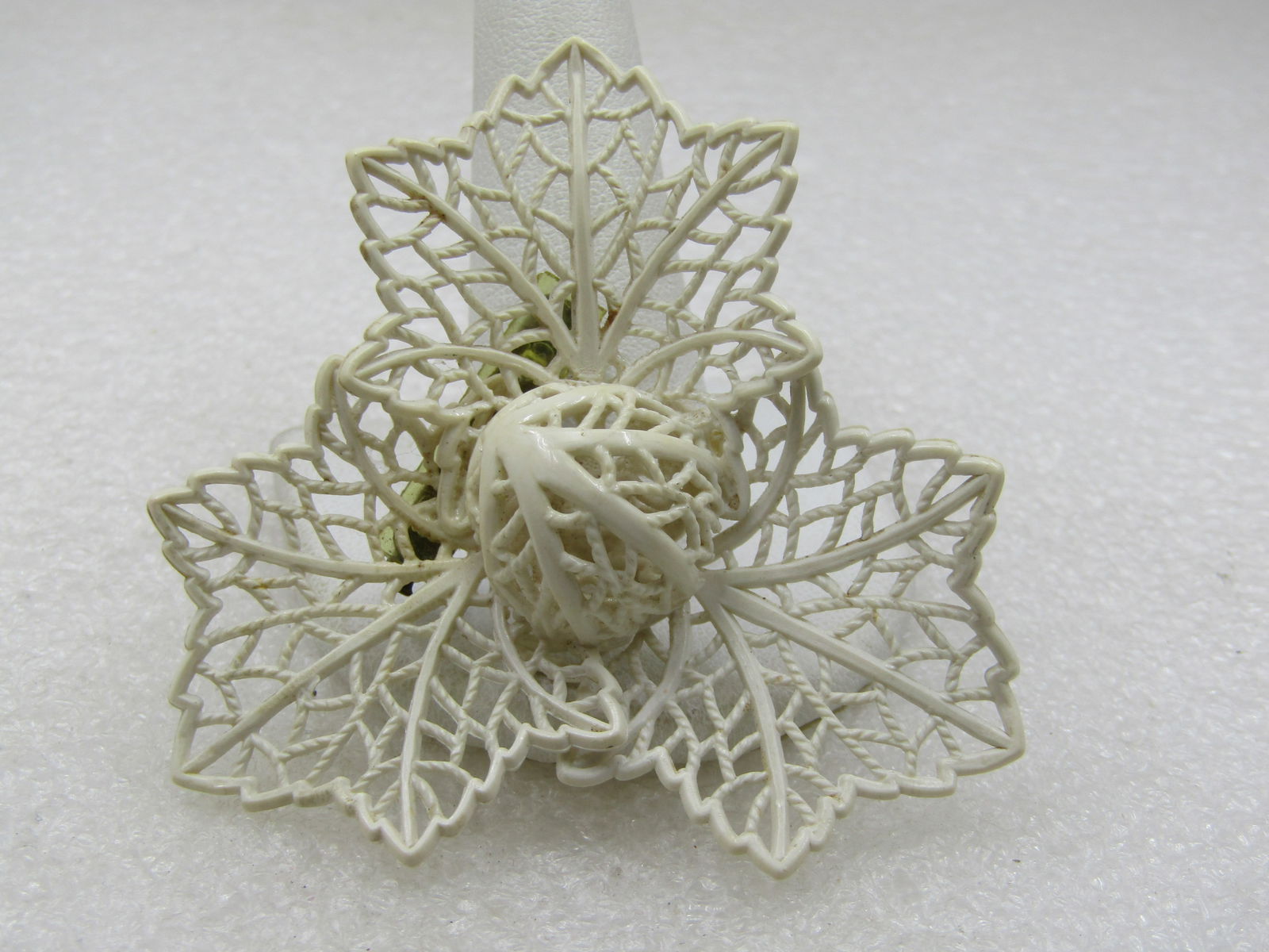 Vintage White Filigree Leaf Brooch, Domed Center, 2.5": Title: Vintage White Filigree Leaf Brooch, Domed Center, 2.5" Description: Vintage White Filigree Leaf Brooch, Domed Center, 2.5". Three white plastic filigree leaves with a center 3/4" half-circled