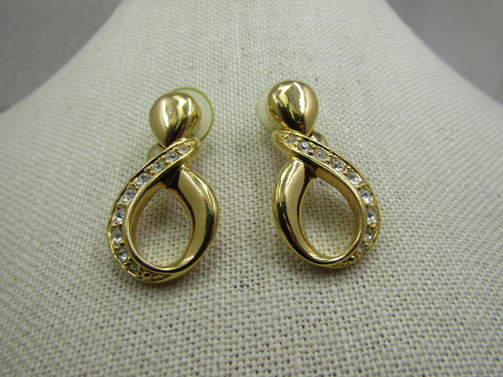 Vintage Avon Rhinestone Figure 8 Earrings, Pierced: Title: Vintage Avon Rhinestone Figure 8 Earrings, Pierced Description: Vintage Avon Rhinestone Figure 8 Earrings, Pierced. Gold tone in an upright modified exfinity dsign with the one side of the