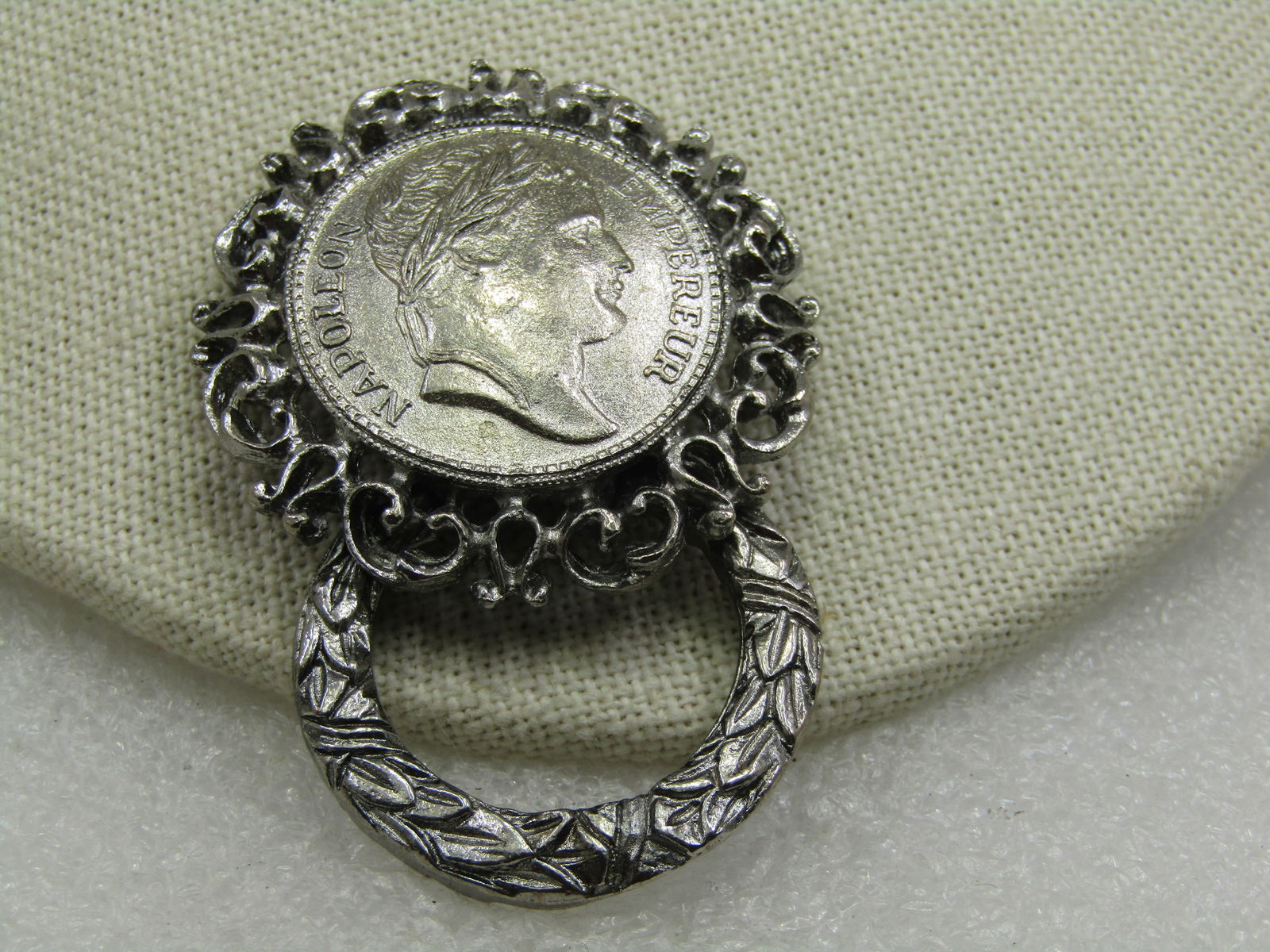 Vintage Faux Napolean Emperor Coin Brooch, 1960's-1970's, 2.25": Title: Vintage Faux Napolean Emperor Coin Brooch, 1960's-1970's, 2.25" Description: Vintage Faux Napolean Emperor Coin Brooch, 1960's-1970's, 2.25" tall and 1.5" wide. Silver tone with an olive-leaf w