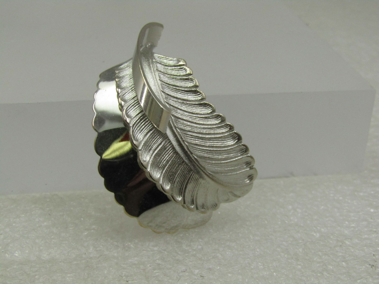 Vintage Silver Plated Double Feather Brooch, 2": Title: Vintage Silver Plated Double Feather Brooch, 2" Description: Vintage Silver Plated Double Feather Brooch, 2" tall and 1.25 wide. One feather is texted and the backone is smooth with a smooth