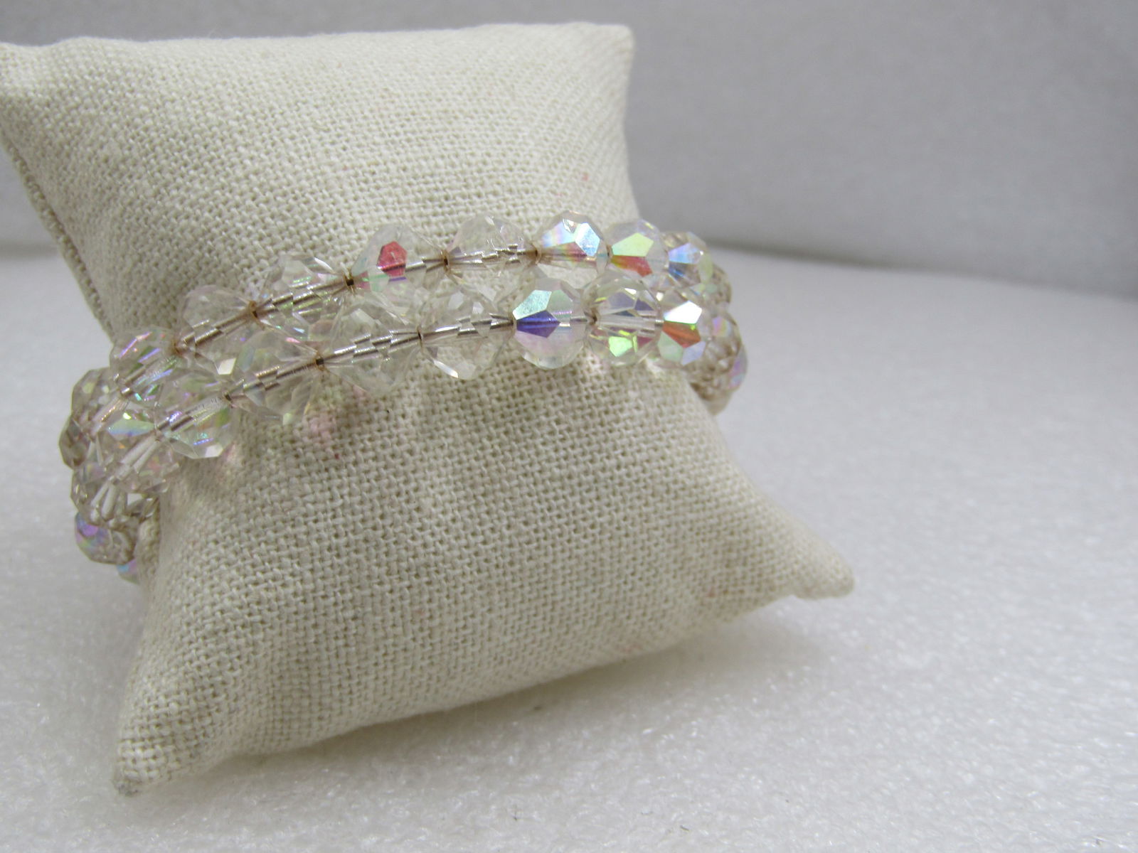 Vintage Auroa Borealis Crystal Beaded Coiled Bracelet: Title: Vintage Auroa Borealis Crystal Beaded Coiled Bracelet Description: Vintage Auroa Borealis Crystal Beaded Coiled Bracelet. 8mm faceted crystal beads. The coil adjusts to most wrist sizes up to