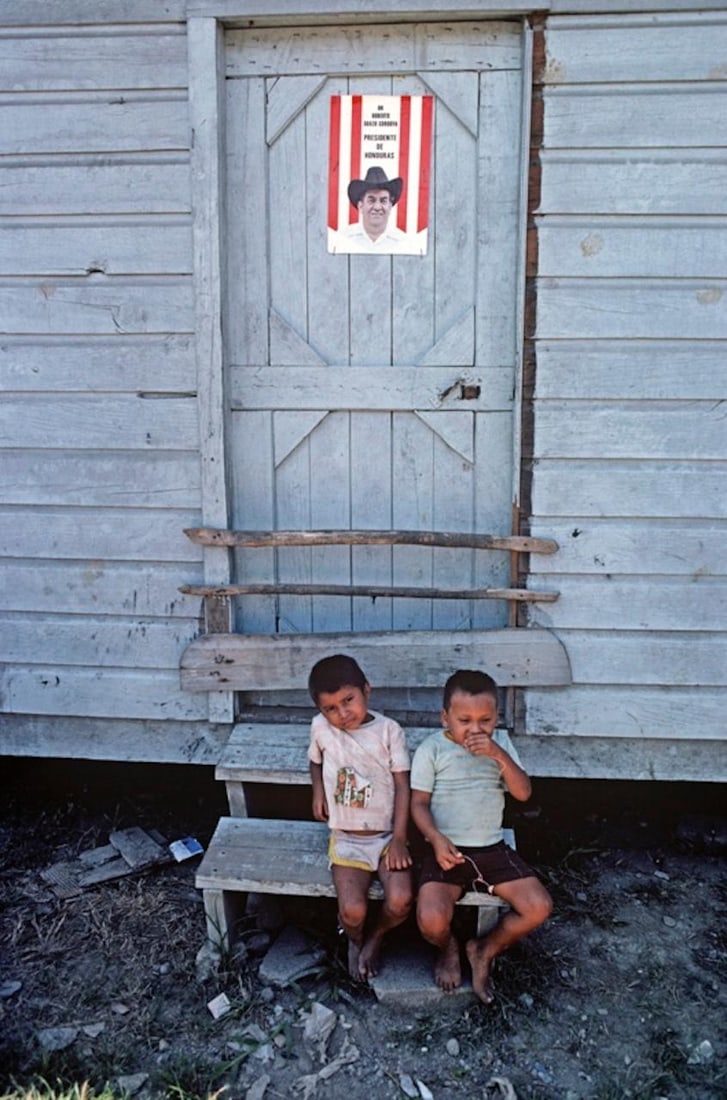 Honduras Porch Steps by Alain Le Garsmeur: 1981 (printed later): Title: Honduras Porch Steps by Alain Le Garsmeur: 1981 (printed later) Description: Porch Steps by Alain Le Garsmeur Two young children sitting outside banana plantation workers' homes, Isletas banana