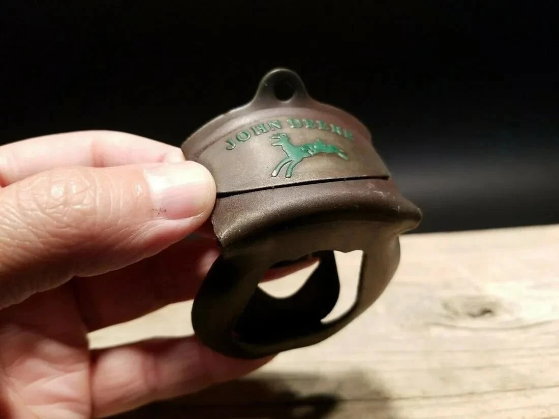 John Deere Beer Bottle Cap Opener: Title:John Deere Beer Bottle Cap OpenerDescription:4" Long Such a neat reproduction cast iron car! As you can see this heavy cast iron car was wonderfully hand painted and distressed to look