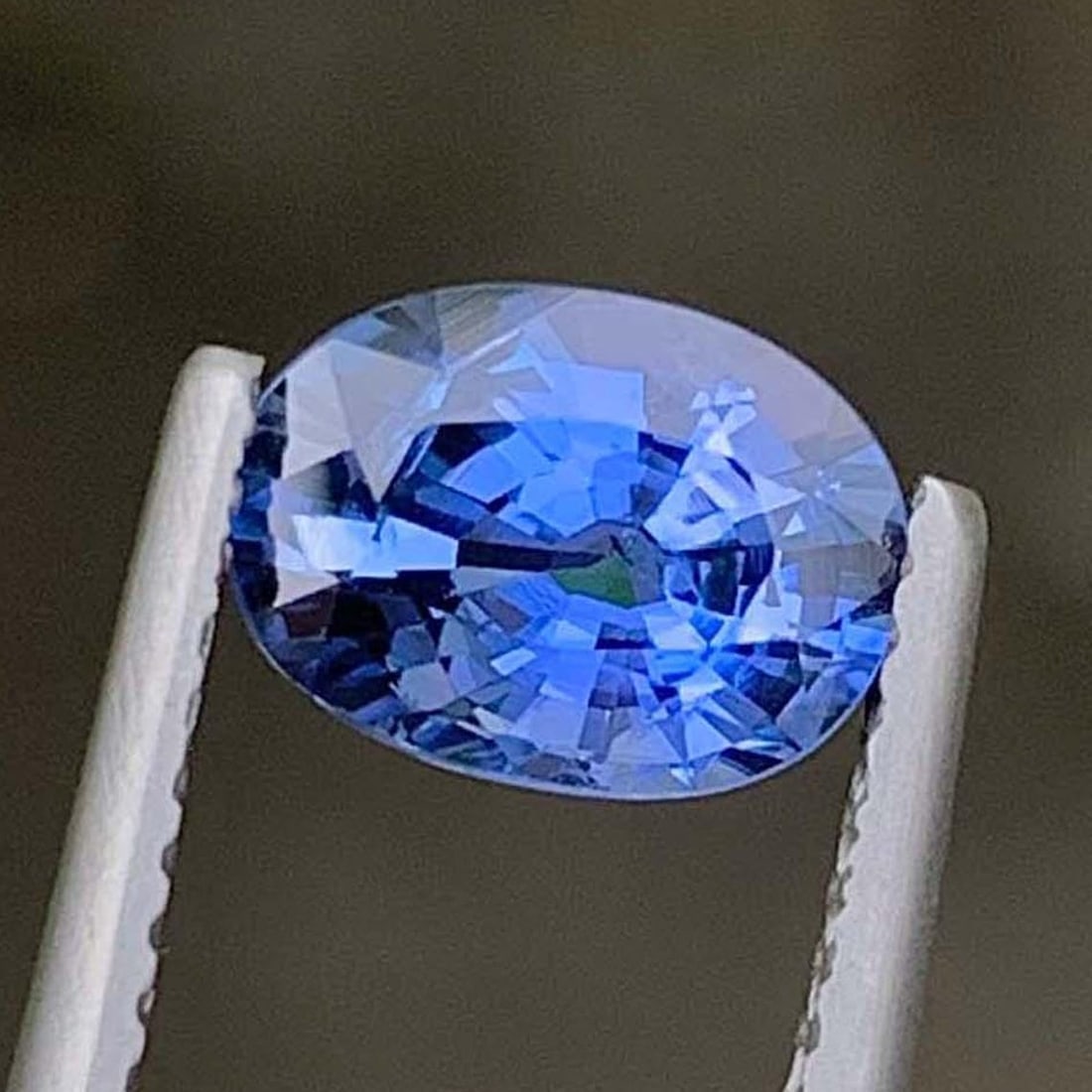 AIG Certified Faceted Blue Sapphire: 1.56 Carat Oval Cut Gemstone (1 of 9)