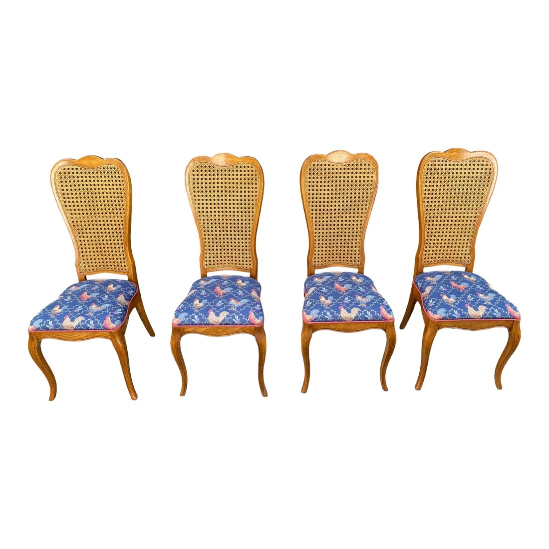 Cane Back Rooster Dining Chairs - Set of 4: Quick Hits: - Set of 4 cane-back dining chairs - Charming chicken-patterned upholstery in blue and pink - Light wood finish with elegant curved legs - Perfect for adding personality to your dining