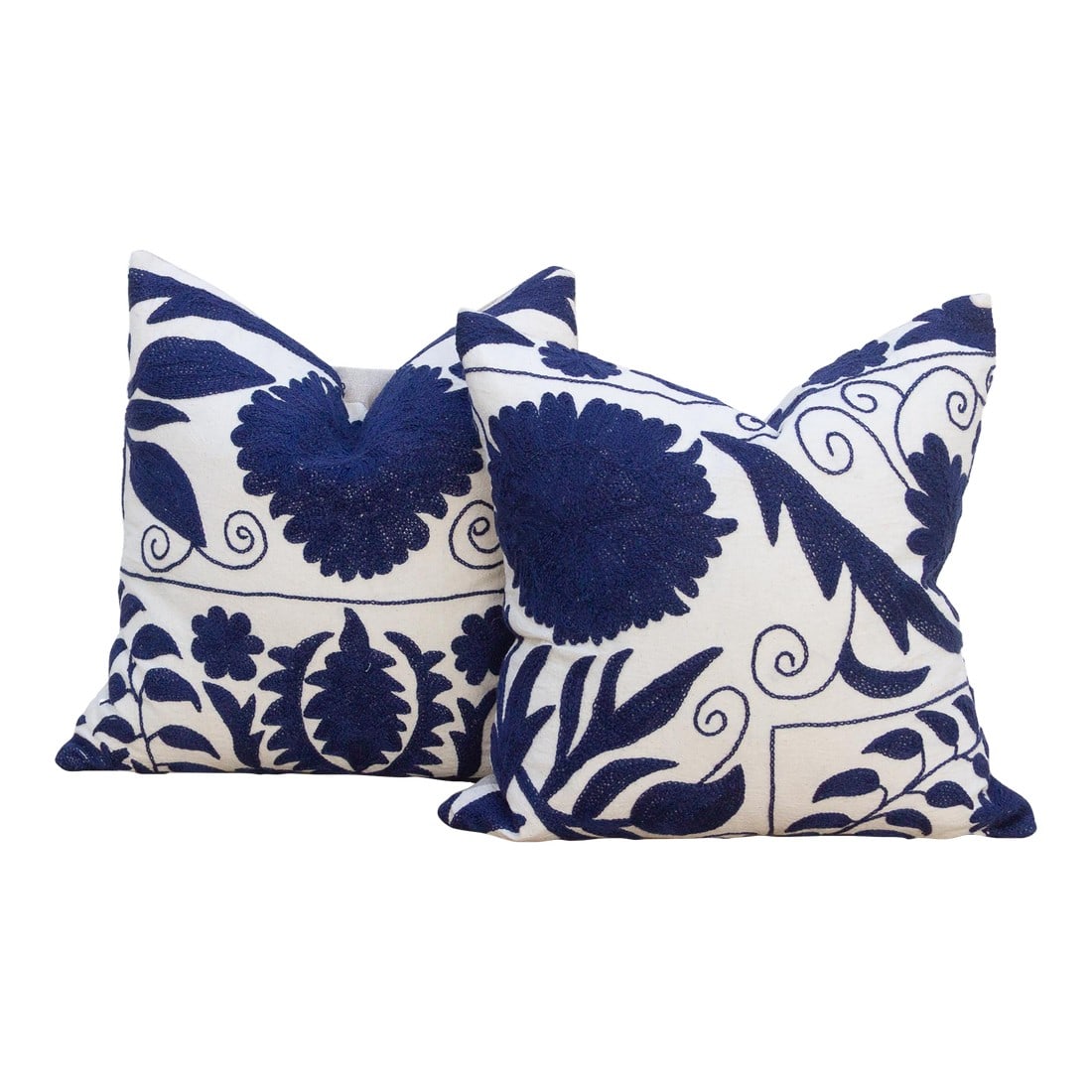 Pair of Indigo Blue Hand Embroidered Suzani Pillows: This magnificent pair of decorative pillows is a true artifact of Central Asian artistry. Each square pillow is crafted from genuine Vintage Suzani textile, a prestigious embroidered cloth originating