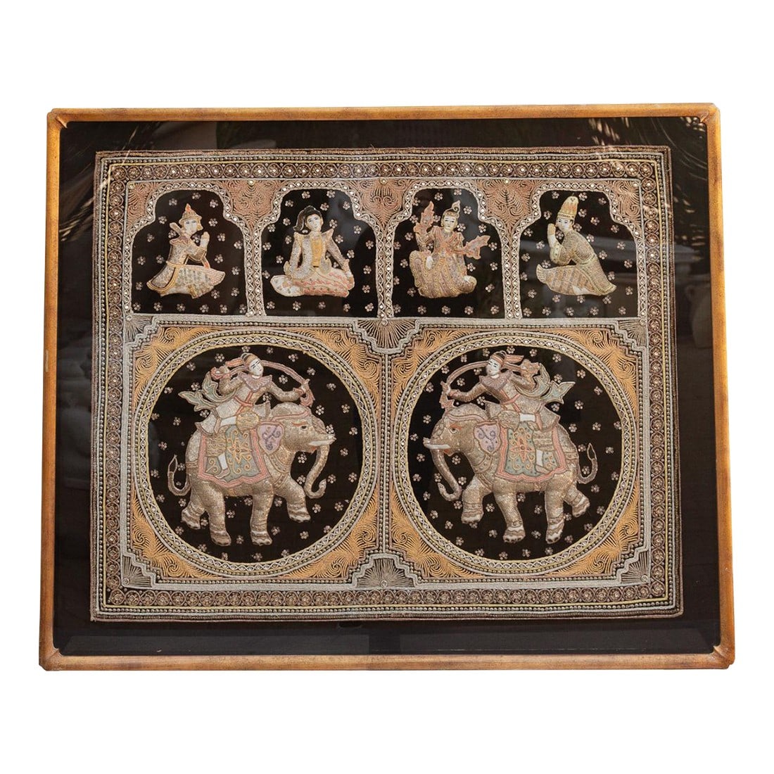 Large Framed Burmese Kalaga Elephants Tapestry: A stunning example of Burmese Kalaga, a traditional form of embroidered tapestry. This piece is crafted on a heavy black velvet ground and features the signature gold thread technique, where metallic
