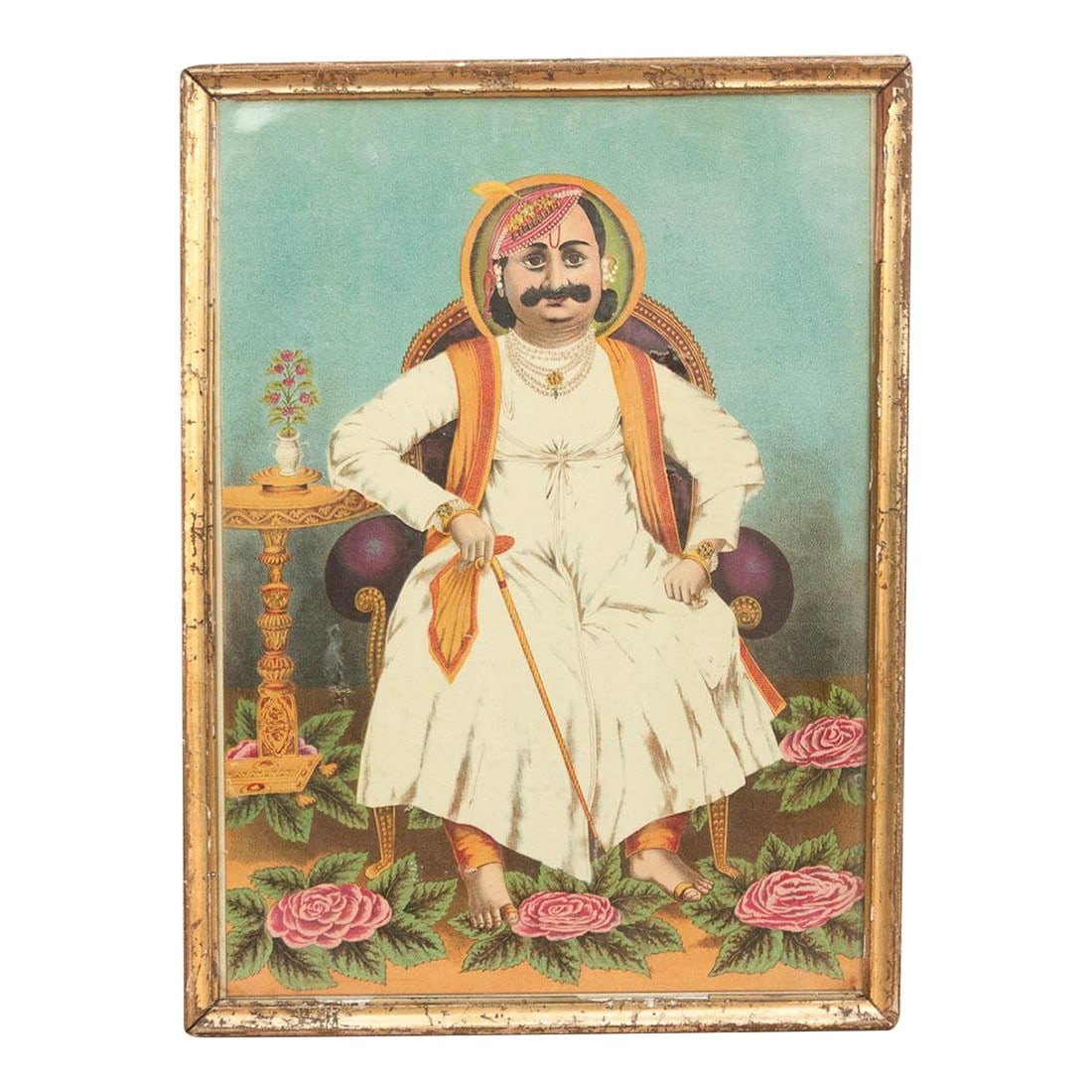 Antique Indian Seated Maharaja Framed Portrait: A captivating portrait that bridges two worlds, this antique painting depicts a Rajput nobleman or Maharaja seated in a European-style upholstered chair. He is dressed in traditional white finery