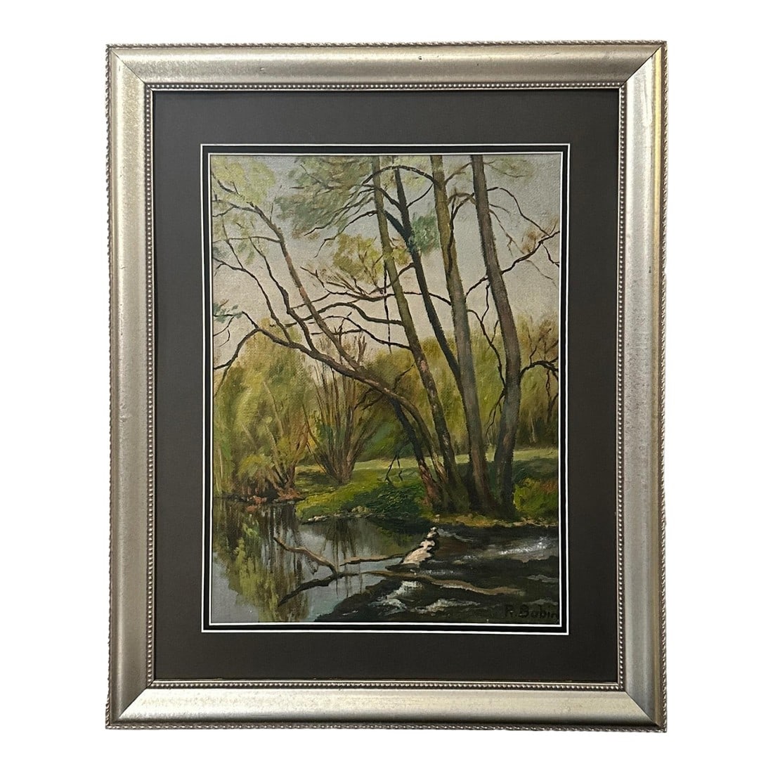 Early 1900s French Quiet Riverbank Landscape Oil Painting: A tranquil French oil on board depicting a serene riverbank where tall trees rise gracefully and lean over the reflective water, their forms mirrored in the gentle current. Painted with a