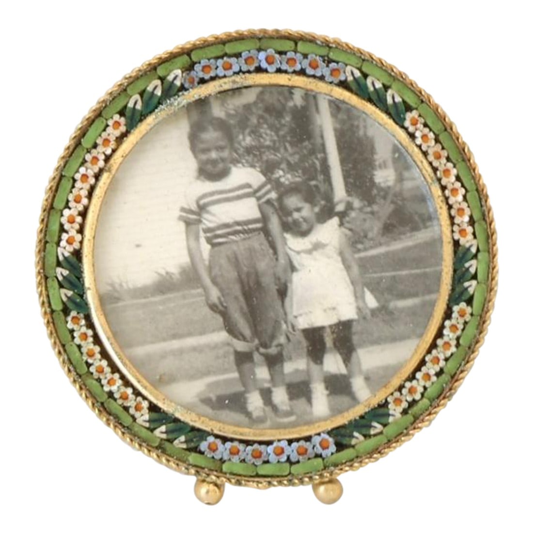 Midcentury Italian Micromosaic Picture Frame: This Italian micromosaic picture frame features finely set glass tesserae arranged in a floral border of jewel tones, encircling a softly rounded gilt metal opening. Each tiny fragment is hand-laid,